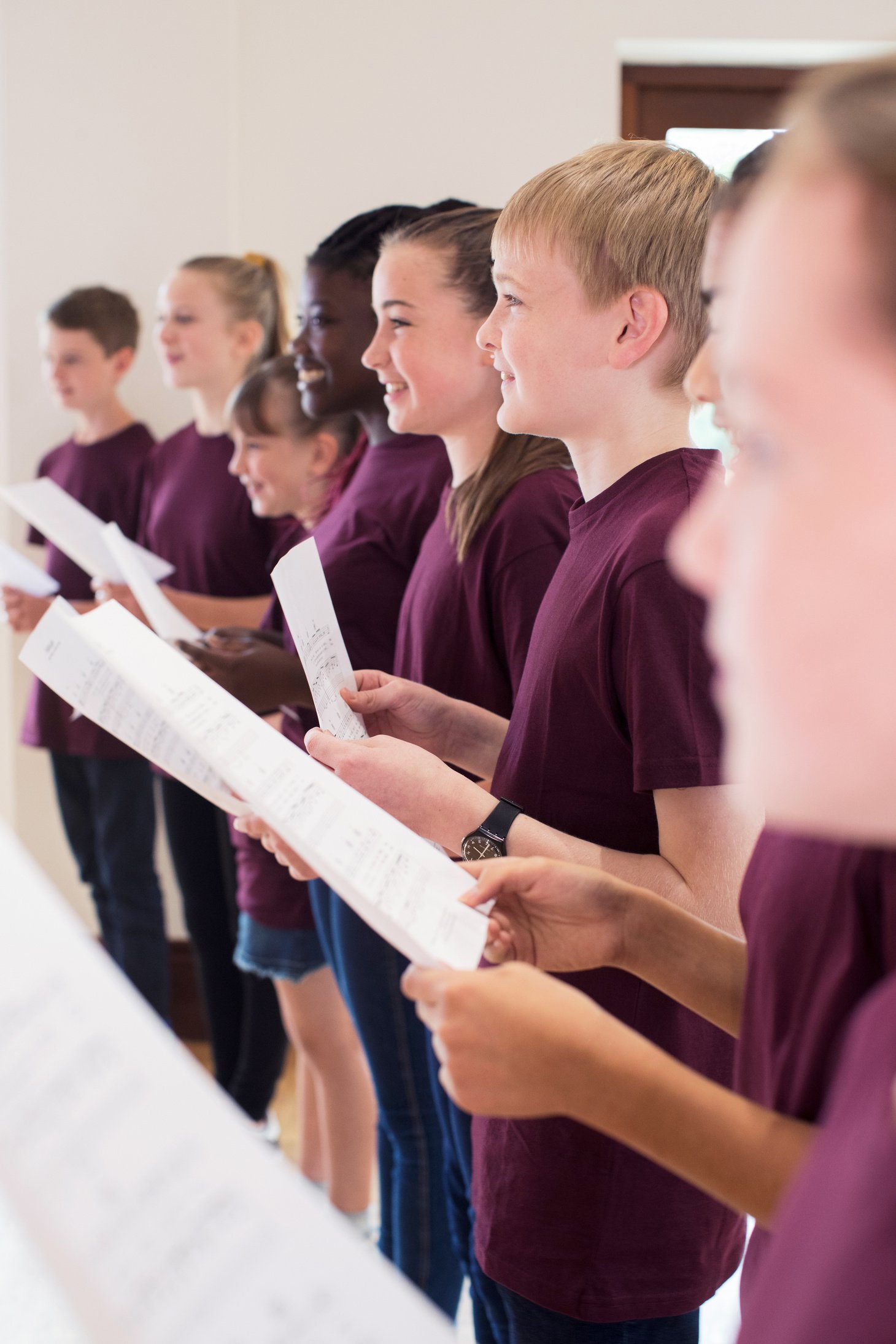 Group Of School Children Singing In Choir Together